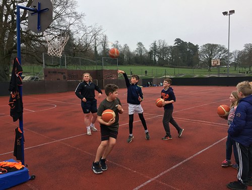 Children playing basketball on the MUGA