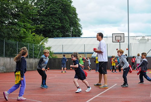 Kids with Coach Gunn on the MUGA